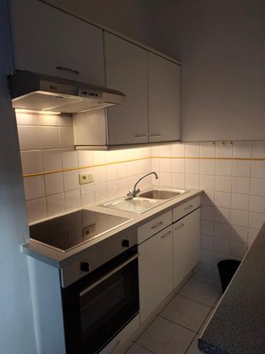 a small kitchen with a sink and a stove at Apartment Descamps in Blankenberge