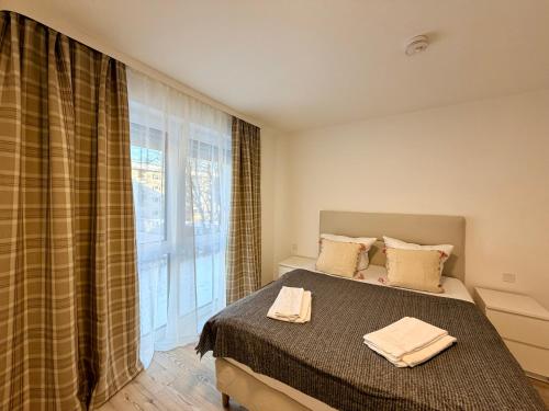 a bedroom with a bed and a large window at GG Apartment 7 in Garmisch-Partenkirchen