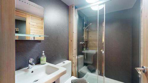 a bathroom with a sink and a glass shower at Orchard Glamping in Catterall