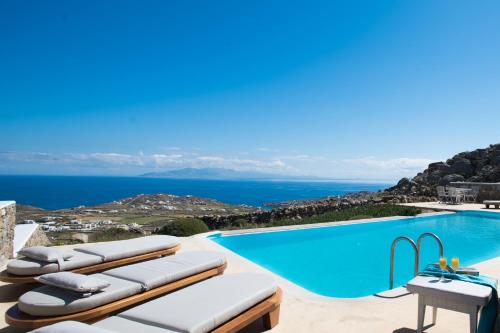 a villa with a pool and a view at Amallini Suites Mykonos in Super Paradise Beach