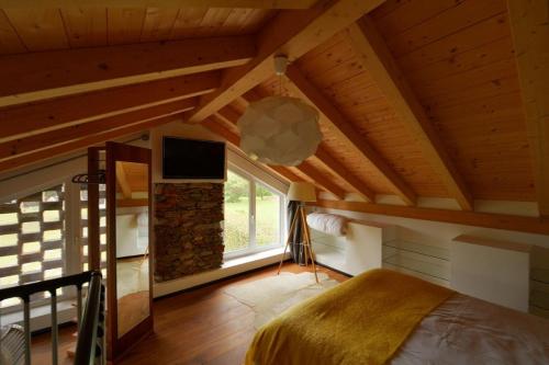 a bedroom with a bed and a tv in a attic at Aurora Villa in Lesa