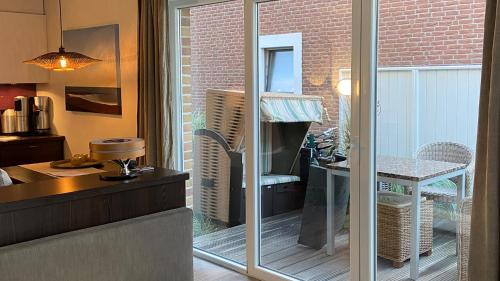 a kitchen with a sliding glass door leading to a patio at Strandhaus Haffkrug in Scharbeutz