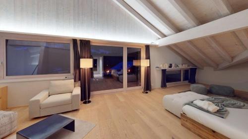 a large living room with a couch and a chair at Chalet Chavanette - Beautiful 7 bedrooms Chalet in Champéry