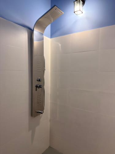 a bathroom with a light attached to the wall at Atarah Beach Hotel in Negombo