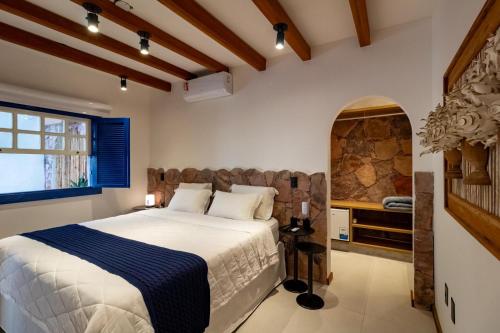 a bedroom with a large bed and a window at Villa Hortensia in Mucugê