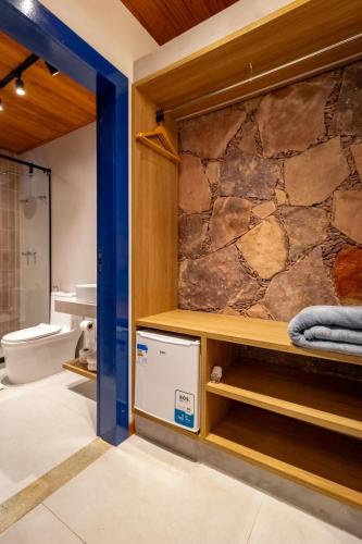 a bathroom with a stone wall at Villa Hortensia in Mucugê