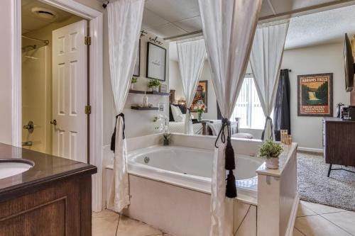 a bathroom with a tub and a sink at 2 King BRs Balcony Resort Amenities Free Tix in Pigeon Forge