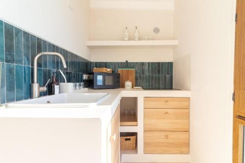 a kitchen with a sink and a microwave at Casa Anciua in San Bernardino