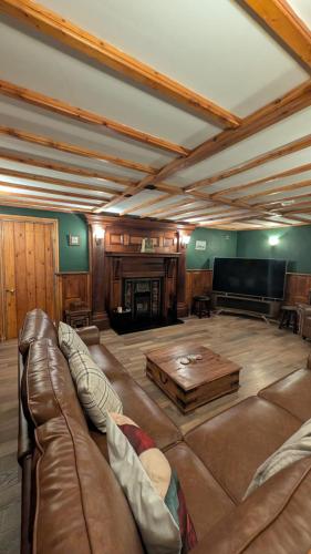 a large living room with a couch and a tv at Bradford Canal Pump House, Shipley near Saltaire in Shipley