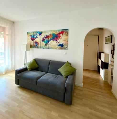 a blue couch in a living room with a painting at Ale’s House in Venice-Lido