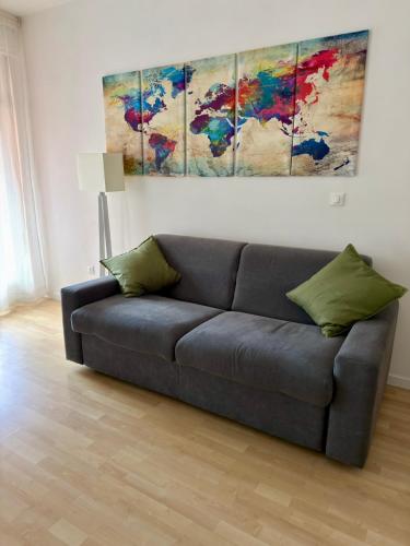 a couch in a living room with a painting on the wall at Ale’s House in Venice-Lido