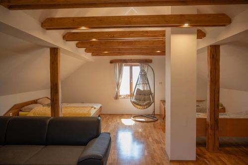 a living room with a couch and a bed at Vineyard cottage Mehak in Telče