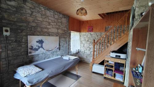 a bedroom with a bed in a stone wall at Siochain House in Templeglantine