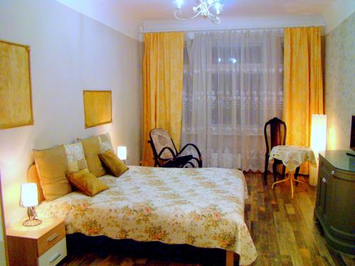 a bedroom with a large bed and a window at Elegant Apartment in Rīga