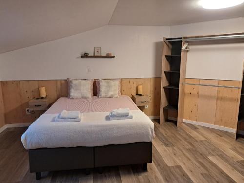 a bedroom with a bed with two towels on it at B&B Hoeve Terwinghe in Gingelom
