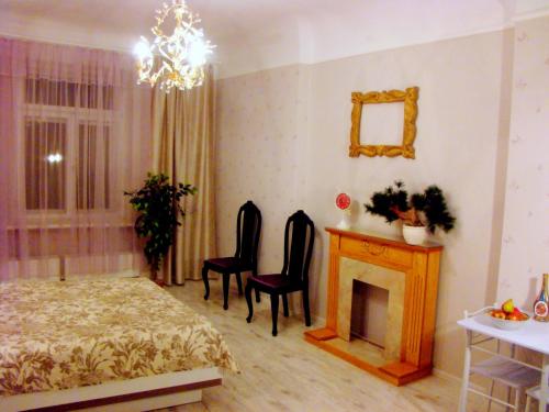 a bedroom with a bed and a fireplace and a mirror at Elegant Apartment in Rīga