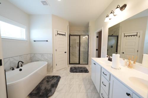 a white bathroom with a tub and a sink at Desoto Rental in Olive Branch