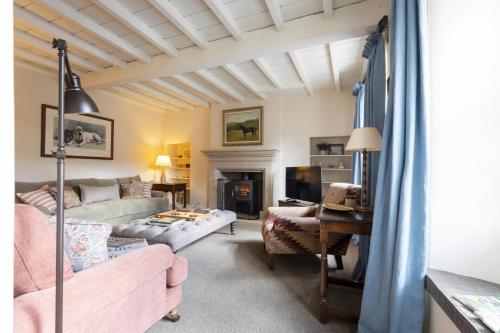 a living room with a couch and a fireplace at 4 Bed in Middleham oc-c34754 in Caldbergh