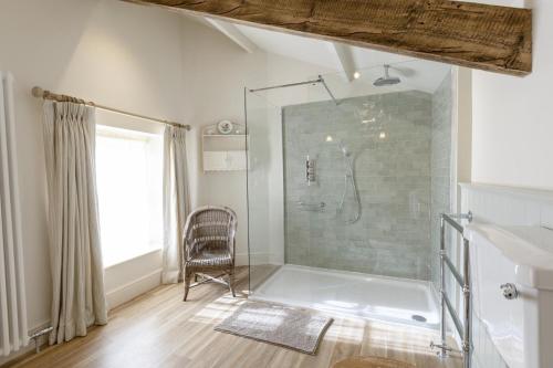 a bathroom with a shower and a chair in it at 4 Bed in Middleham oc-c34754 in Caldbergh