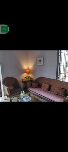 a living room with a couch and a table at pondicherry hostel in Pondicherry