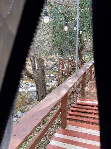 a wooden bridge with stairs leading to a river at 川辺-Kawabe-BBQ-川遊び in Hanno