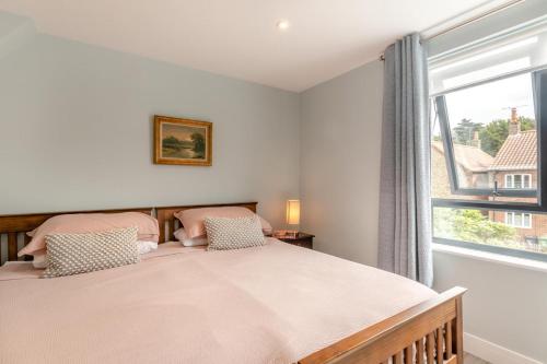 a bedroom with a large bed and a window at 2 Bed in Holt oc-l31797 in Holt