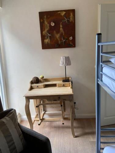 a wooden desk in a room with a lamp on it at Strandhaus Haffkrug in Scharbeutz