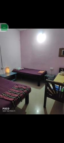 a small room with a bed and a table at pondicherry hostel in Pondicherry