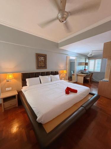 a bedroom with a large bed with a red object on it at Roamia Retreat - Lighthouse in Langkawi Islands