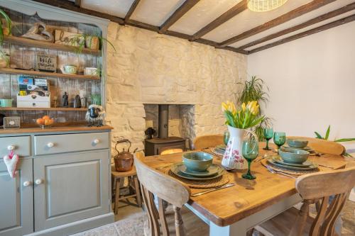 a dining room with a table and a stone fireplace at 2 Bed in Trefil oc-n34478 in Nant-y-bwch