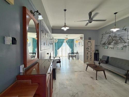 a living room with a couch and a table at Roamia Retreat - Lighthouse in Langkawi Islands