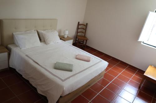 a bedroom with a bed with two pillows on it at Qt Refúgio de Rubiães Villa 1-2 Paredes de Coura in Paredes de Coura