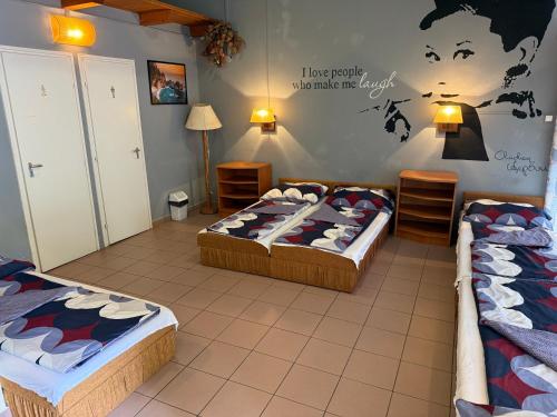 a bedroom with two beds and a wall with a map at Beach Hostel Balatonboglár in Balatonboglár