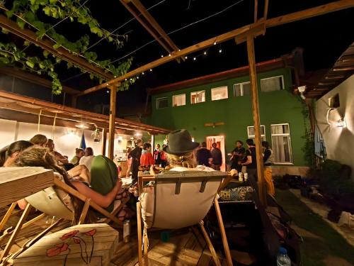a group of people sitting in chairs under a building at PORTALA Urban Lodge in Rila