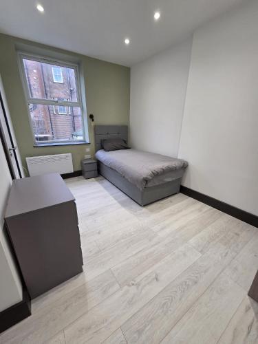 a bedroom with a bed and a desk in it at 1066 Apart Hotel in Hastings