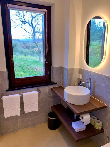 a bathroom with a sink and a large window at Residenza Marrone in Montefalco