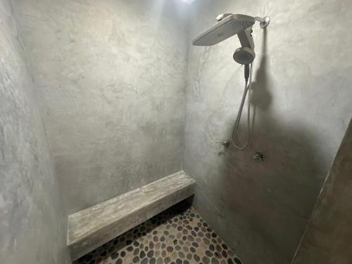 a shower with a shower head in a bathroom at Hotel Almendros Bonfil in Acapulco