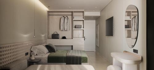 a bedroom with a bed and a sink and a mirror at Sun Palace Protaras Waterpark Resort in Protaras