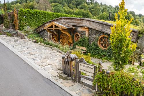 a building with a sign on the side of a road at Pagórek w Brennej in Brenna