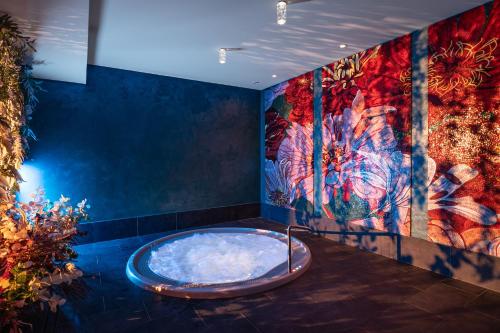 a hot tub in a room with a painting at Zámeček Petrovice u Karviné in Petrovice u Karviné