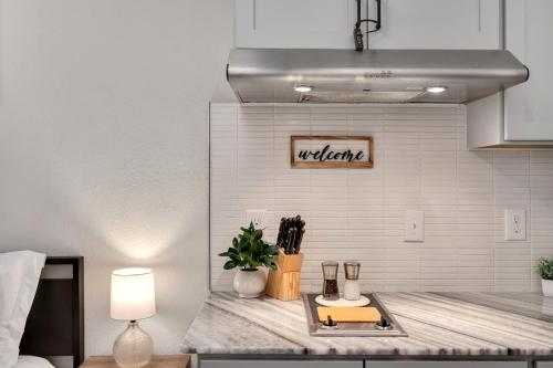a kitchen with a counter top with a table at Upscale Midtown Studio and Private Balcony in Raleigh