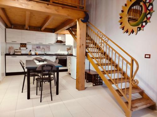 a kitchen and dining room with a table and chairs at CASA NATURA - CAMPAGNA e MARE - in Marconia