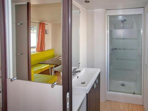 a bathroom with a sink and a shower and a mirror at Camping La Siesta - Maeva in L'Aiguillon-la-Presqu'île