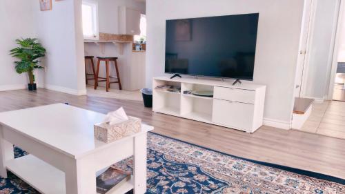 a living room with a large flat screen tv at Yuan's Cozy 4BR House in Charlottetown in Cornwall