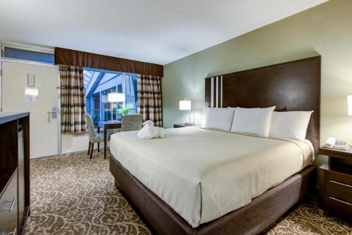 a hotel room with a large bed and a desk at Glenstone Lodge in Gatlinburg