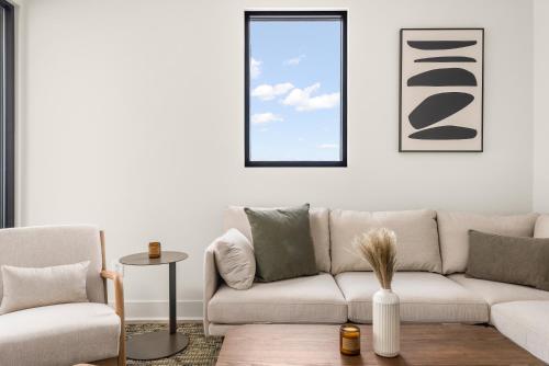 a living room with a couch and two chairs at The Eighteen by Kasa in Nashville