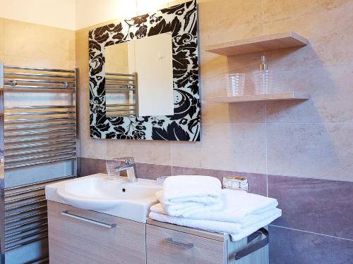 a bathroom with a sink and a mirror at Apartment Bella Vista In Mezzegra in Mezzegra