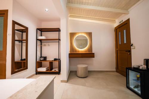 a room with a hallway with a mirror and a door at ABEDINI Boutique Hotel Ksamil in Ksamil