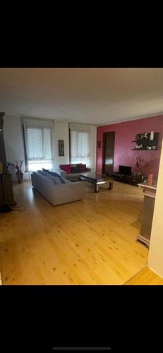 a large living room with a couch and wooden floors at Charlotte room in Bassano del Grappa