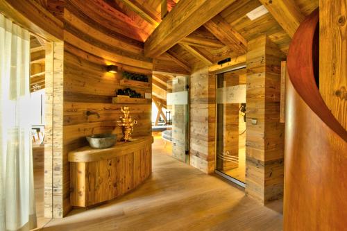 a bathroom with a sink in a wooden house at Hotel Villa Monica in Dobbiaco